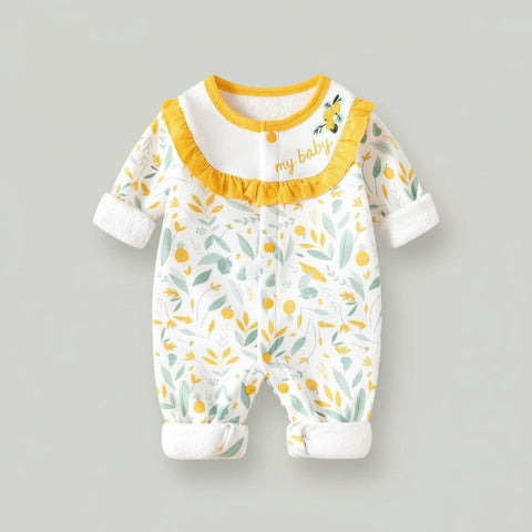 Baby onesie with yellow trim and leaf pattern on a gray background