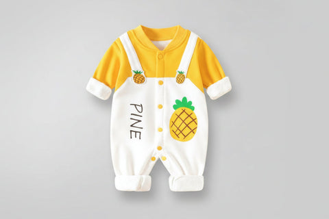 Baby onesie with pineapple design and text on a gray background