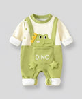 Green baby romper with dinosaur design on a gray background
