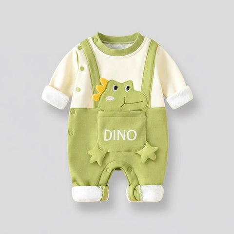 Green baby romper with dinosaur design on a gray background