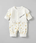 Baby outfit with floral top and pants on a gray background