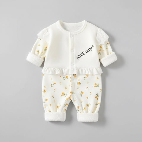 Baby outfit with floral top and pants on a gray background