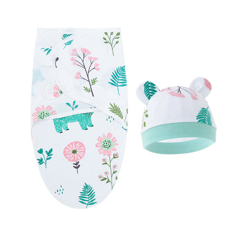 Baby hat and swaddle with floral and animal pattern on a white background
