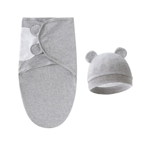 Gray baby swaddle and hat set on a white background