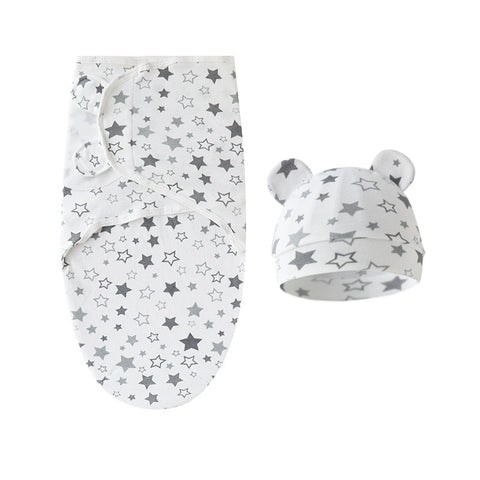 Baby swaddle and hat set with star pattern on a white background