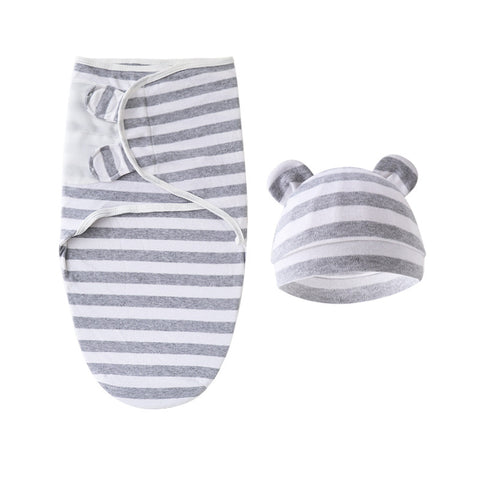 Gray and white striped baby swaddle and hat set on a white background