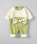 Green and white baby romper with elephant design on a gray background