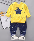 Children's yellow shirt and blue pants set with a star design on a gray background