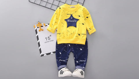 Children's yellow shirt and blue pants set with a star design on a gray background