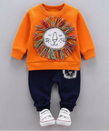 Children's outfit with orange sweatshirt and navy pants on a gray background
