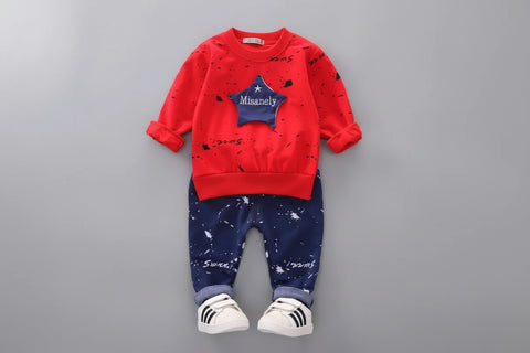 Red and blue children's outfit with star design on a gray background