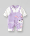 Purple baby romper with bunny design on a gray background