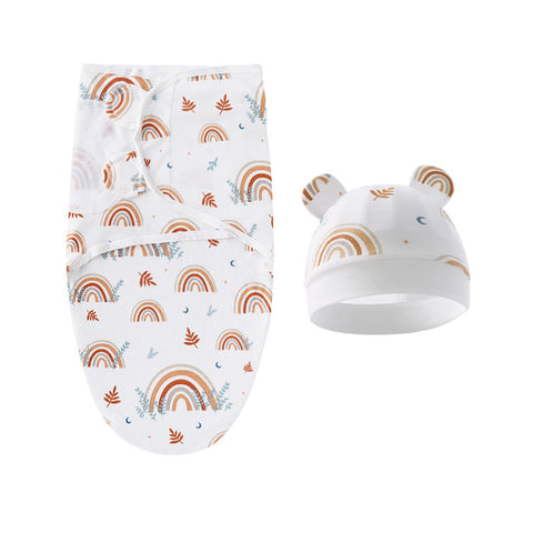 Baby swaddle with rainbow pattern and matching hat on a white background