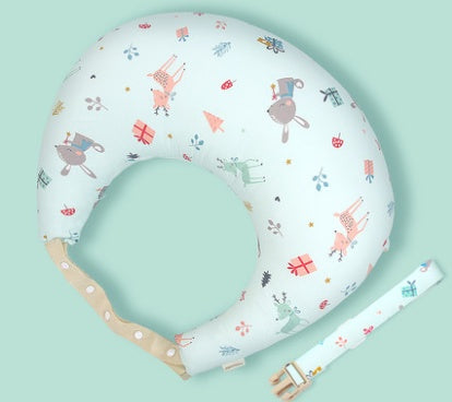Baby boppy pillow with colorful patterns on a light green background