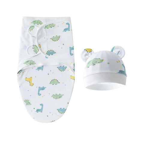 Baby swaddle and hat set with dinosaur pattern on a white background