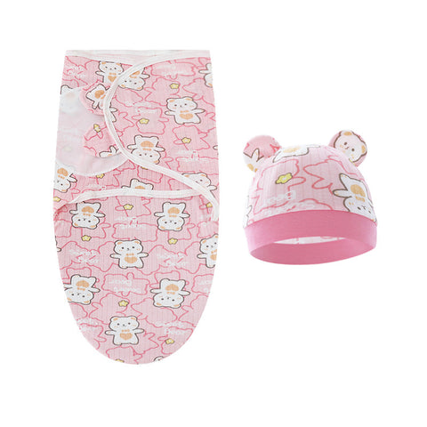 Baby swaddle and hat set with teddy bear pattern on a white background