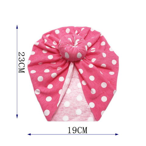 Pink headscarf with white polka dots and measurements on a white background