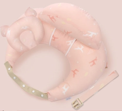 Pink baby head support with white stars and a green strap on a light pink background