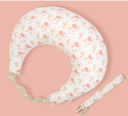 Nursing pillow with floral pattern and strap on a pink background