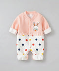 Baby onesie with pink top and polka dot pants on a gray background, featuring the brand 'Xiao Qiudong'.