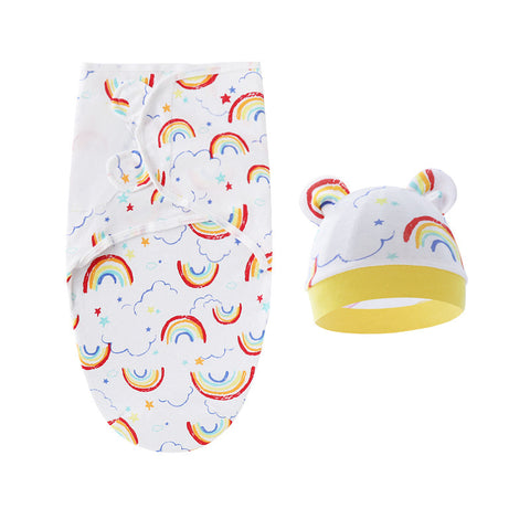 Baby swaddle with rainbow pattern and matching hat on a white background