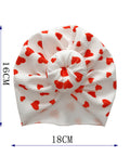 White headband with red heart patterns and measurements on a white background