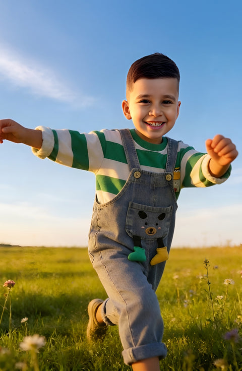 Child running in a field with a clear blue sky