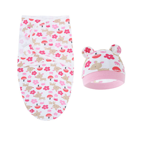 Baby swaddle and hat set with pink floral and deer pattern on a white background