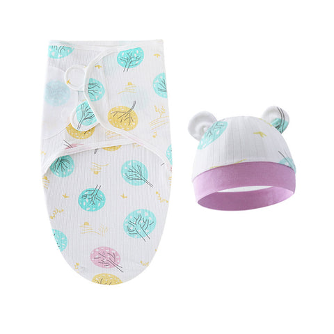 Baby swaddle with leaf pattern and matching hat on a white background