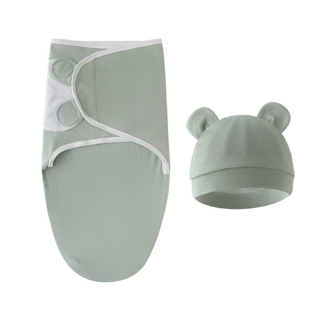 Baby swaddle and hat set in light green on a white background