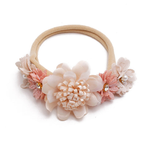 Floral headband with pink and white flowers on a white background