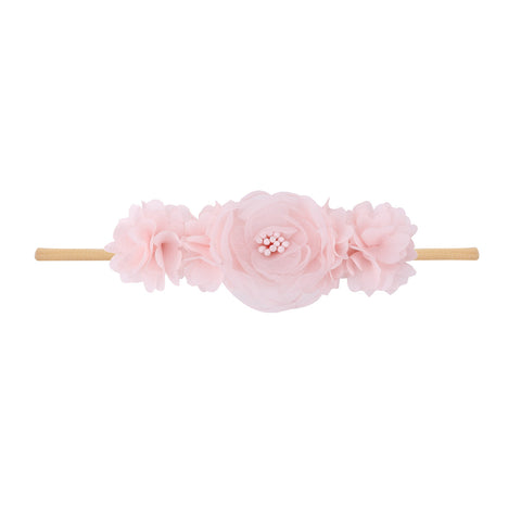 Pink floral headband on a white background