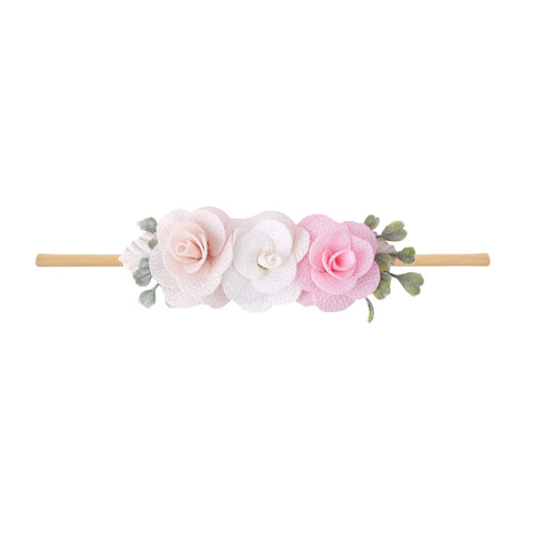 Floral headband with pink and white flowers on a white background