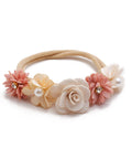 Floral headband with pink and beige flowers on a white background