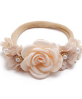 Beige floral headband with pearls on a white background