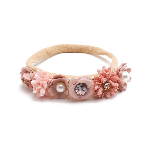 Beige headband with pink floral decorations on a white background
