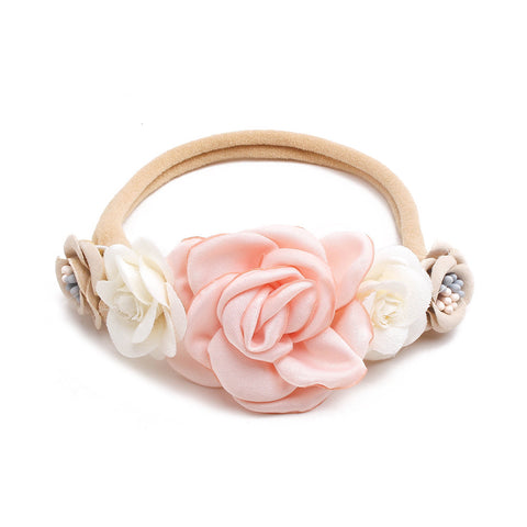 Floral headband with pink and white flowers on a white background