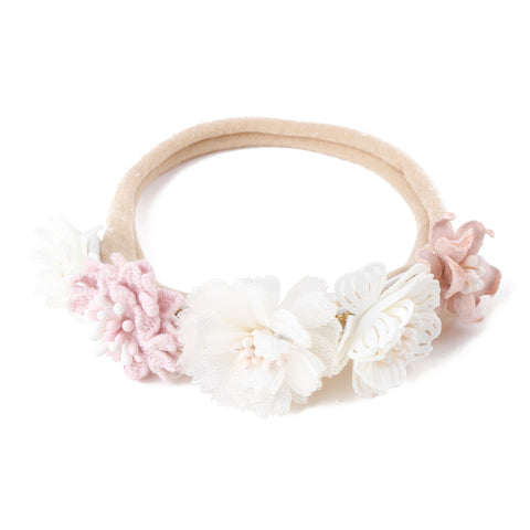 Floral headband with pink and white flowers on a white background
