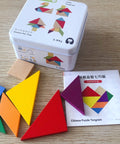 Colorful geometric puzzle pieces with a tin box on a wooden surface