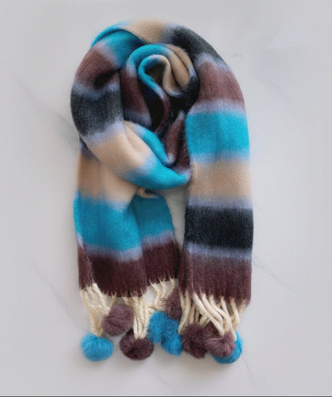 Striped scarf with pom-pom ends on a white background