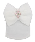 White ribbed knit top with a large bow and pink embellishments on a white background
