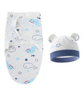Baby swaddle with whale pattern and matching hat on a white background
