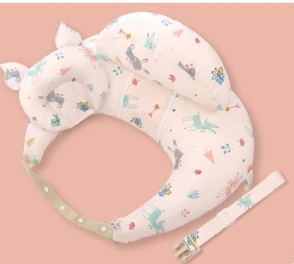 Baby support pillow with colorful animal pattern on a pink background