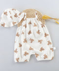 Baby romper with teddy bear pattern, straw hat, and yellow flowers on a white background