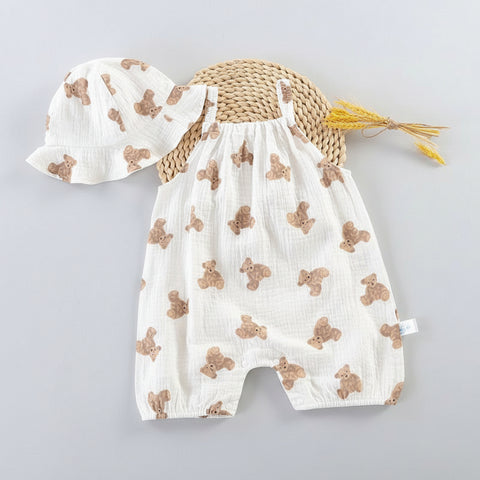 Baby romper with teddy bear pattern, straw hat, and yellow flowers on a white background