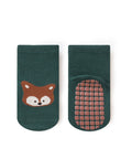 Green socks with a fox design and textured sole on a white background