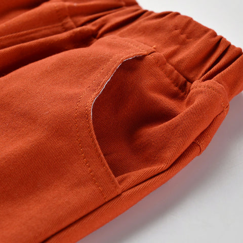 Close-up of orange pants with a pocket on a white background