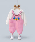 Children's outfit with pink bunny overalls and white hoodie on a hanger.