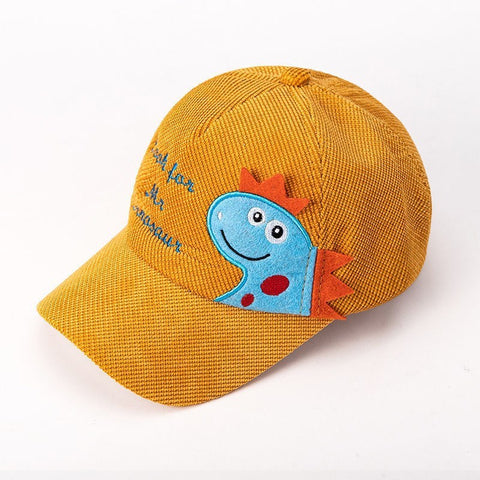 Yellow cap with a blue dinosaur patch on a white background