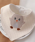 Baby bib with owl design on a white surface